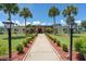 Community building entrance with walkway, landscaping, and palm trees at 233 Tarpon Ln, Oldsmar, FL 34677