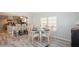 Bright dining area with glass table and four chairs, adjacent to kitchen at 233 Tarpon Ln, Oldsmar, FL 34677