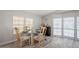 Dining area with round table, four chairs, and large windows at 233 Tarpon Ln, Oldsmar, FL 34677