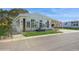 Single-wide yellow home with carport and American flag at 233 Tarpon Ln, Oldsmar, FL 34677