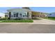 White single-wide manufactured home with carport, landscaping, and American flag at 233 Tarpon Ln, Oldsmar, FL 34677