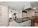 Open kitchen with granite island, offering view into living room at 233 Tarpon Ln, Oldsmar, FL 34677