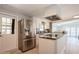 Stainless steel refrigerator and kitchen island with granite countertop at 233 Tarpon Ln, Oldsmar, FL 34677