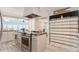 Kitchen island with granite countertop and stainless steel range at 233 Tarpon Ln, Oldsmar, FL 34677
