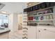 Convenient laundry room with washer, dryer, and shelving at 233 Tarpon Ln, Oldsmar, FL 34677