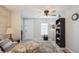 Living room with floral armchair, bookcase, and ceiling fan at 233 Tarpon Ln, Oldsmar, FL 34677