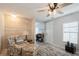 Living room with floral armchair, wood accent wall, and ceiling fan at 233 Tarpon Ln, Oldsmar, FL 34677