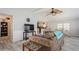 Living room with brown couch, TV, and view into dining area at 233 Tarpon Ln, Oldsmar, FL 34677
