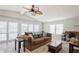 Living room with brown couch and large windows at 233 Tarpon Ln, Oldsmar, FL 34677