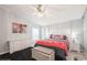 Main bedroom with dresser, ceiling fan, and plush bedding at 233 Tarpon Ln, Oldsmar, FL 34677