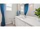 Bathroom with white vanity, quartz countertop, and teal curtains at 2375 Warren Acres Blvd, Wesley Chapel, FL 33543