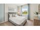 Bedroom with gray upholstered bed and large window at 2375 Warren Acres Blvd, Wesley Chapel, FL 33543
