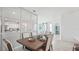 Open dining room with mirrored wall and view into the living room at 2375 Warren Acres Blvd, Wesley Chapel, FL 33543