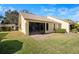A cozy backyard featuring a screened lanai and a stone patio, perfect for relaxing outdoors at 2549 Oakleaf Ln # 36C, Clearwater, FL 33763