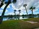 Serene waterfront view with palm trees and dock at 336 Shaddock St, Tarpon Springs, FL 34689