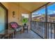 Intimate screened balcony featuring chairs and a pleasant neighborhood view at 4621 Gulf Of Mexico Dr # D10, Longboat Key, FL 34228