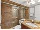 Bathroom with tiled walk-in shower and granite vanity at 4621 Gulf Of Mexico Dr # D10, Longboat Key, FL 34228