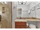 Bathroom with granite counters, wood cabinets, and tiled shower stall at 4621 Gulf Of Mexico Dr # D10, Longboat Key, FL 34228