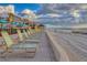 Beach area with lounge chairs and umbrellas near the ocean at 4621 Gulf Of Mexico Dr # D10, Longboat Key, FL 34228