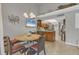 Open concept kitchen and dining area with granite counters and stainless appliances at 4621 Gulf Of Mexico Dr # D10, Longboat Key, FL 34228