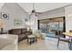 Comfortable living room with neutral tones and large windows overlooking the balcony at 4621 Gulf Of Mexico Dr # D10, Longboat Key, FL 34228