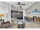 Bright living room featuring stylish furniture, a ceiling fan, and balcony access at 4621 Gulf Of Mexico Dr # D10, Longboat Key, FL 34228