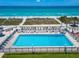 Aerial view of community pool area with ocean view at 4621 Gulf Of Mexico Dr # D10, Longboat Key, FL 34228