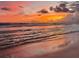 Picturesque beach scene featuring a colorful sunset reflecting on the water and wet sand at 4621 Gulf Of Mexico Dr # D10, Longboat Key, FL 34228