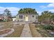 Gray house with yellow door, landscaped yard, and walkway at 4809 11Th S Ave, St Petersburg, FL 33711