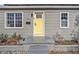 Yellow front door with gray house exterior at 4809 11Th S Ave, St Petersburg, FL 33711