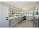 Bright laundry room with tile floor, shelving, and exterior access at 4809 11Th S Ave, St Petersburg, FL 33711