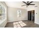 Living room with hardwood floors, ceiling fan, and kitchen view at 4809 11Th S Ave, St Petersburg, FL 33711