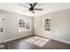 Living room with hardwood floors, ceiling fan, and large windows at 4809 11Th S Ave, St Petersburg, FL 33711
