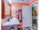 Bathroom with coral walls, a vanity with granite countertop and a large mirror at 8624 Fantasia Park Way, Riverview, FL 33578