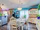 Bright dining room with floral tablecloth, white hutch and blue walls at 8624 Fantasia Park Way, Riverview, FL 33578