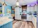 Bright kitchen featuring granite countertops and stainless steel appliances at 8624 Fantasia Park Way, Riverview, FL 33578