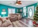 Living area with teal walls, hardwood floors, and comfortable seating at 8624 Fantasia Park Way, Riverview, FL 33578