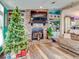 Living room features a stone fireplace, large TV, and Christmas tree at 8624 Fantasia Park Way, Riverview, FL 33578