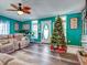 Living room with teal walls, hardwood floors, and Christmas tree at 8624 Fantasia Park Way, Riverview, FL 33578