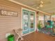 Inviting covered porch with teal doors and lake view at 8624 Fantasia Park Way, Riverview, FL 33578
