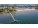 Aerial view of a pier extending into the water with beach and buildings at 907 Bahia Del Sol Dr, Ruskin, FL 33570