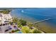 Aerial view of waterfront property with pier, beach, and parking at 907 Bahia Del Sol Dr, Ruskin, FL 33570