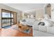 Living room with hardwood floors, white sofas, and water views at 907 Bahia Del Sol Dr, Ruskin, FL 33570