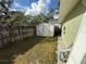Backyard with storage shed and fenced area at 10002 Memorial Hwy, Tampa, FL 33615