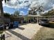 Ranch style home with carport and small front yard at 10002 Memorial Hwy, Tampa, FL 33615