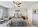 Spacious bedroom with ceiling fan, plush bedding, and ample natural light at 10347 Heron Hideaway Loop, Land O Lakes, FL 34638