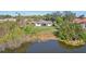 Backyard view of the house showing the canal and green space at 107 Temple Rd, Venice, FL 34293