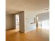 Light-filled living room features laminate wood floors and kitchen access at 122 Loblolly Ct # B, Oldsmar, FL 34677