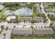 An aerial view of townhomes surrounding a large pond, showcasing the community's layout and landscaping at 12827 Buffalo Run Dr, Gibsonton, FL 33534