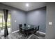 Dining room with a glass table, seating for six, and a sliding glass door at 12827 Buffalo Run Dr, Gibsonton, FL 33534